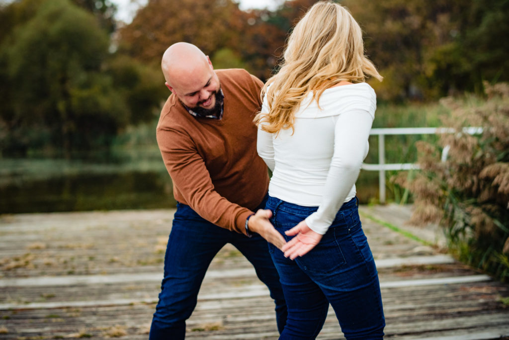 Dan wiping off Ashley's wet butt at their FDR Park Engagement Session