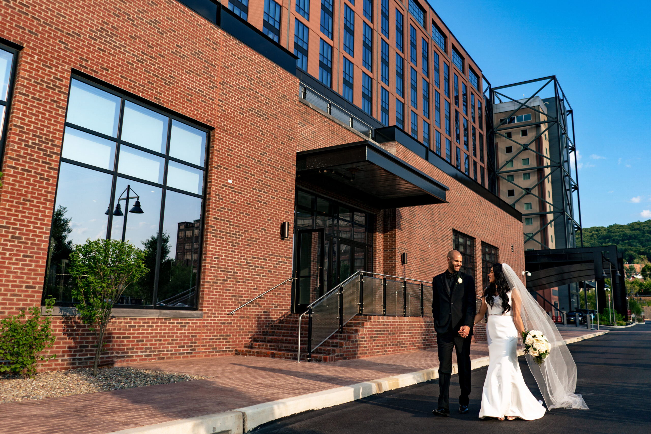 wedding couple walking outside of wind creek event center